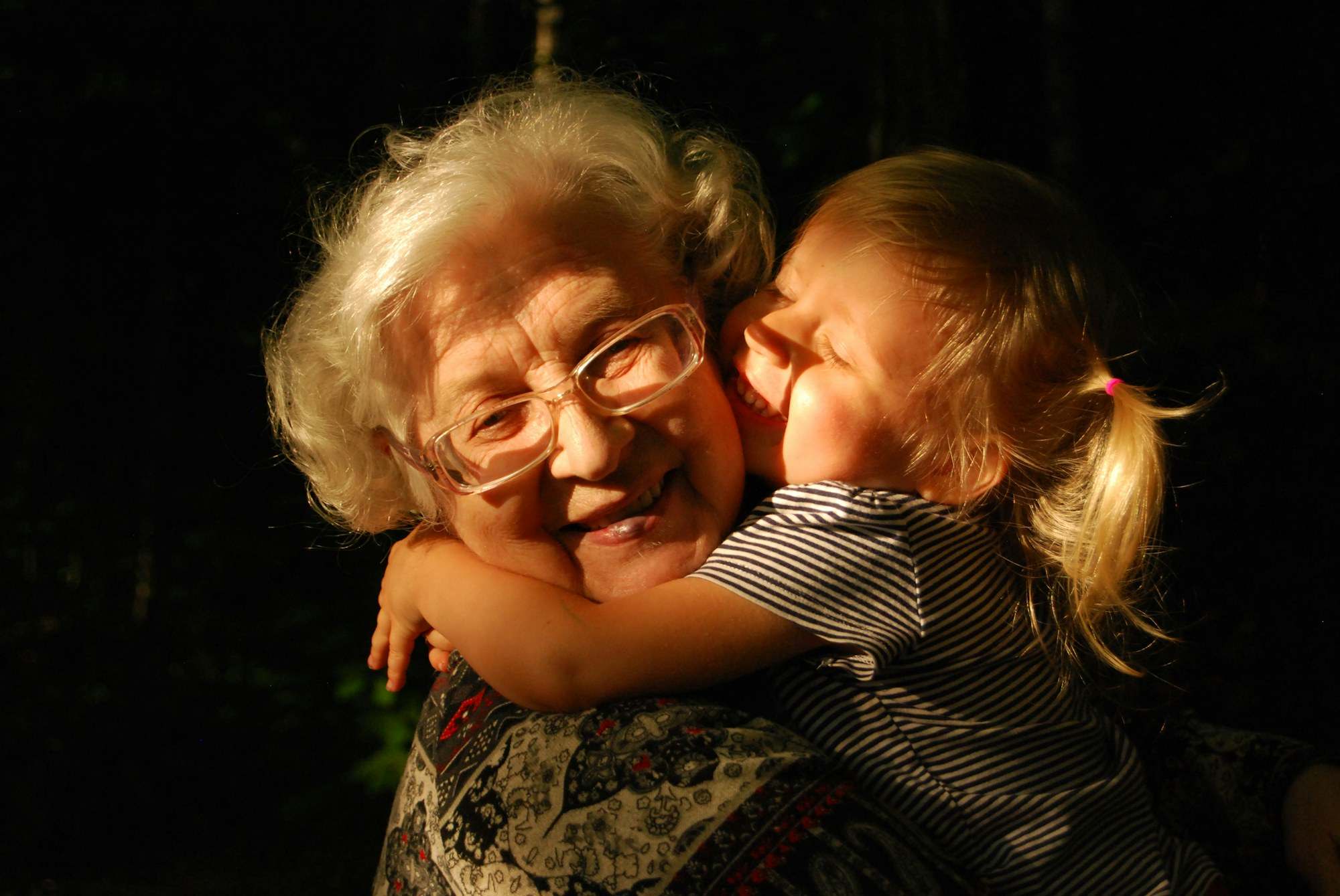 Grandmother hugging her granddaughter