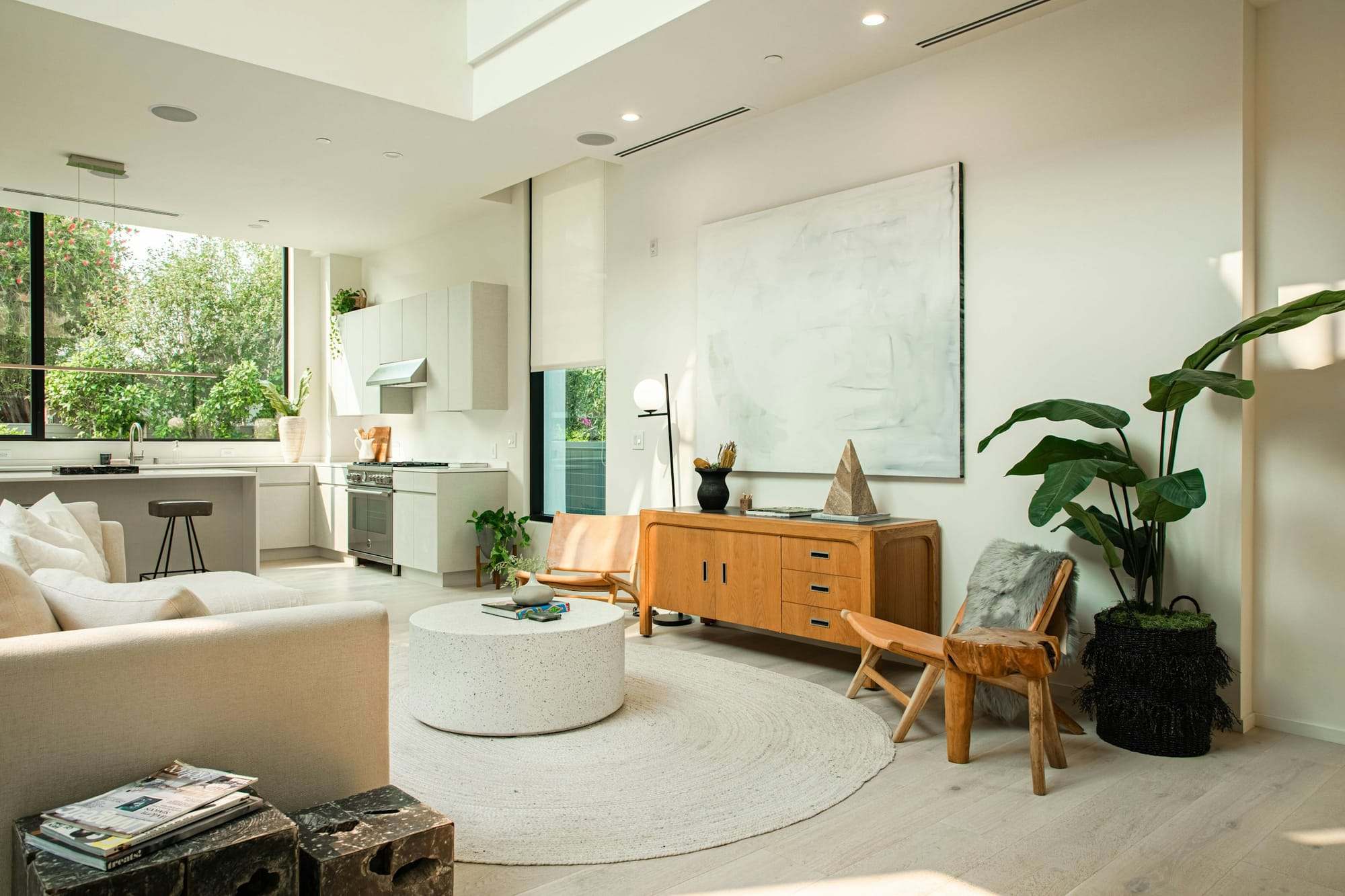 Bright living room with plants and warm wood furniture